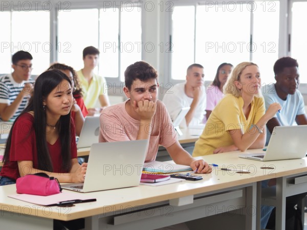 Group of multi-ethnic teenage student listening to the lesson in class
