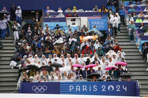 July 26th, 2024 - Paris, France: Spectators under pouring rain during the Opening Ceremony of the Paris 2024 Olympics (photo by Mickael Chavet)