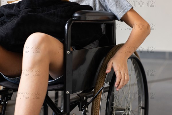 Holding wheel, student in wheelchair attending school activities