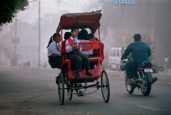 A cycle rickshaw full of school-children