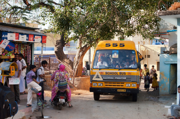 Indian school bus going through the indian town Puttaparthi. Andhra Pradesh, India