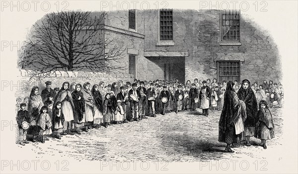 THE COTTON FAMINE: OPERATIVES WAITING FOR THEIR BREAKFAST IN MR. CHAPMAN'S COURTYARD, MOTTRAM, NEAR MANCHESTER, 1862
