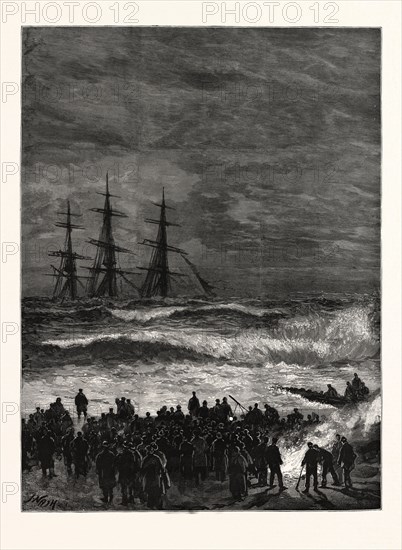 THE WRECK OF THE THREE-MASTED SHIP "BENVENUE" AT SANDGATE: When night came on a bonfire was lighted on the beach by the crowds who were watching the wreck, to cheer those of the unfortunate crew who were still clinging to the rigging