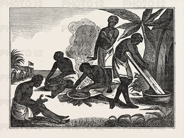 NATIVES OF MADAGASCAR PREPARING BREAD FROM THE MANIOC ROOT