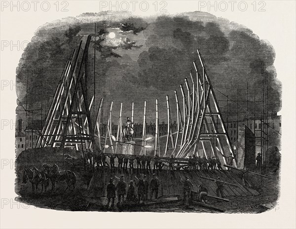 RAISING THE TRUSSES OF THE BUILDING IN LEICESTER SQUARE, LONDON, UK, FOR MR. WYLD'S LARGE MODEL OF THE EARTH, 1851 engraving