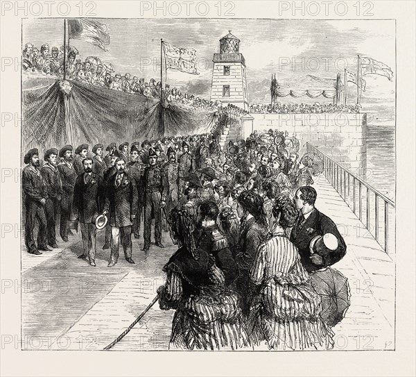 INAUGURATION OF THE HOLYHEAD BREAKWATER AND HARBOUR OF REFUGE BY H.R.H. THE PRINCE OF WALES: THE PRINCE OF WALES AND THE DUKE OF EDINBURGH RETURNING ALONG THE BREAKWATER, WALES, UK, 1873 engraving