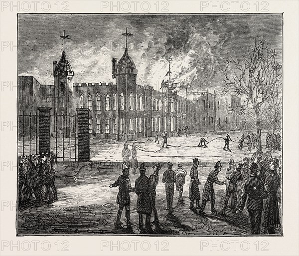 THE FIRE AT THE ROYAL MILITARY ACADEMY AT WOOLWICH, UK: THE SCENE AT 6.15 A.M.: THE NORTH EAST TOWER BURNING, 1873 engraving
