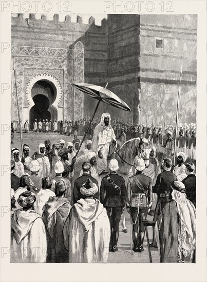SIR CHARLES EUAN-SMITH'S MISSION TO THE COURT OF MOROCCO: THE RECEPTION BY THE SULTAN; Preceded by a crowd of slaves, led horses, and two men with immensely long spears, the Emperor Mulai Hassan rode forth. He was dressed in white, and was mounted on a big grey horse, with saddle and horse-furniture of pale apple-green silk., 1892 engraving
