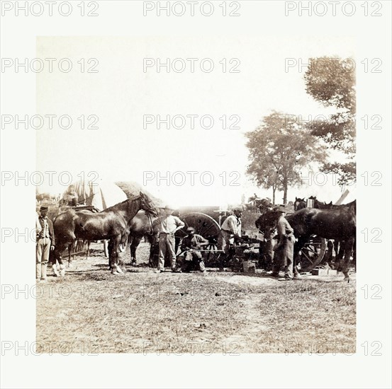 American Civil War: Army Blacksmith and Forge, Antietam, Sept., 1862, Union army blacksmith at work surrounded by horses and other men at General McClellan's headquarters in Antietam. Photo, albumen print, By Alexander Gardner, 1821 1882, Scottish photographer who emigrated to the United States in 1856. From Gardner Photographic Art Gallery, Seventh Street, Washington