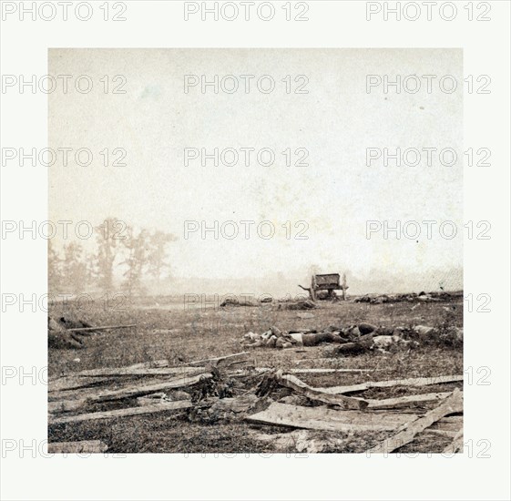 American Civil War: View on battle field of Antietam where Sumner's corps charged the enemy. Scene of terrific conflict, showing devastation after the battle with dead soldiers on the battlefield and a wagon in the background. Photo, albumen print, By Alexander Gardner, 1821 1882, Scottish photographer who emigrated to the United States in 1856. From Gardner Photographic Art Gallery, Seventh Street, Washington