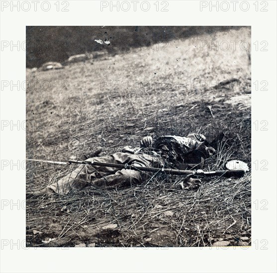 American Civil War: War effect of a shell on a Confederate soldier at battle of Gettysburg, emains of a dead soldier on the battlefield. Photo, albumen print, By Alexander Gardner, 1821 1882, Scottish photographer who emigrated to the United States in 1856. From Gardner Photographic Art Gallery, Seventh Street, Washington