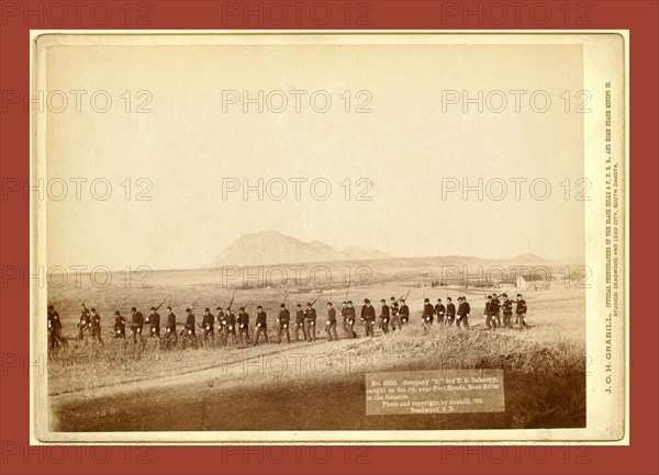 Company C, 3rd U.S. Infantry, caught on the fly, near Fort Meade. Bear Butte in the distance, John C. H. Grabill was an american photographer. In 1886 he opened his first photographic studio