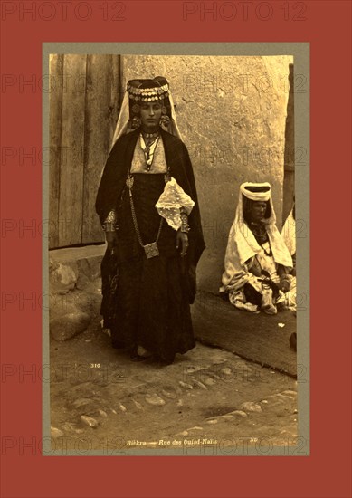 Biskra, Rue des Ouled Nai ¨ ls, Neurdein brothers 1860 1890, the Neurdein photographs of Algeria including Byzantine and Roman ruins in Tébessa and Thamugadi; mosques, shrines, public buildings, palaces, and street scenes in Mostaganem, Biskra, Algiers, Tlemcen, Constantine, Oran, and Sidi Bel Abbès; and the cathedral at Carthage. Portraits of Algerian people include Berbers, Ouled Naïl women, and prisoners in Annaba. Tunisian views include mosques, buildings, and street scenes in Tunis.