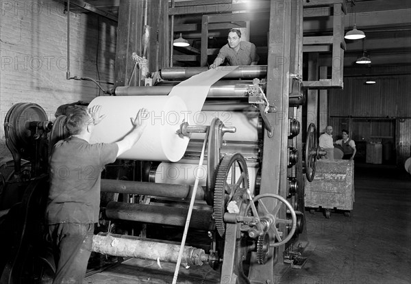 Mt. Holyoke, Massachusetts - Paper. American Writing Paper Co. Super-calender - putting on roll, starting operation, 1936, Lewis Hine, 1874 - 1940, was an American photographer, who used his camera as a tool for social reform. US,USA