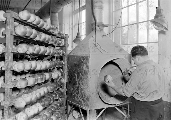 Mt. Holyoke, Massachusetts - Paragon Rubber Co. and American Character Doll. Spraying face, hands, and arms (Jewish) A plus, 1936, Lewis Hine, 1874 - 1940, was an American photographer, who used his camera as a tool for social reform. US,USA