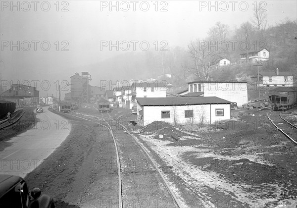 Scott's Run, West Virginia. Pursglove Mines Nos. 3 and 4 - This is the largest company on Scott's Run. Scene shows main Scott's Run Highway and atmosphere loaded with coal dust and typical of Scott's Run on any working day, March 1937, Lewis Hine, 1874 - 1940, was an American photographer, who used his camera as a tool for social reform. US,USA