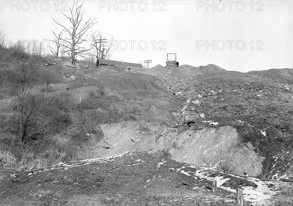 Scott's Run, West Virginia. Worked out coal mine near Pursglove mine No. 4 camp - Scene taken from main highway. This scene is typical of a dozen or more mines that have been closed and left to decay in the community. Note trees killed by mine operations and mine cars left to the elements, March 1937, Lewis Hine, 1874 - 1940, was an American photographer, who used his camera as a tool for social reform. US,USA