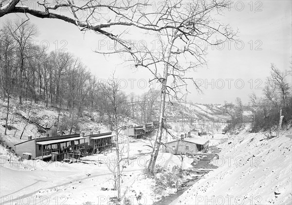 Scott's Run, West Virginia. The Patch - One of the worst camps in Scott's Run. The stream in an auxiliary branch that flows into Scott's Run. The main valley of Scott's Run can be seen towards the right of this picture. These houses were originally built as single bachelor apartments; there are from six to eight separate housekeeping units in the buildings. Many of them are now occupied by families living in one room, March 1937, Lewis Hine, 1874 - 1940, was an American photographer, who used his camera as a tool for social reform. US,USA