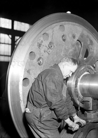 Eddystone, Pennsylvania - Railroad parts. Baldwin Locomotive Works. Machinist finishing axle on large driving wheels (80 inches in diameter) on newest type of locomotive, March 1937, Lewis Hine, 1874 - 1940, was an American photographer, who used his camera as a tool for social reform. US,USA