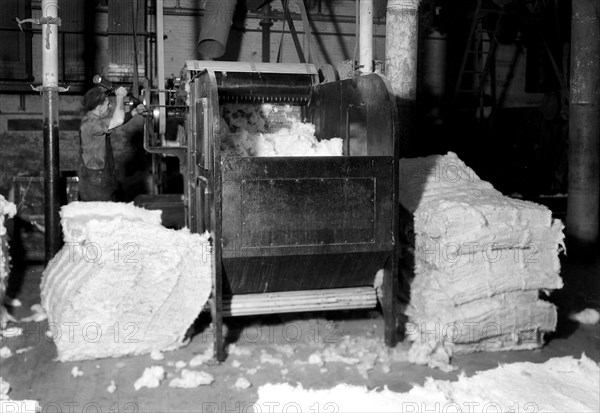 Manchester, New Hampshire - Textiles. Pacific Mills. Opener picker. Cotton from several bales of different grades are mixed and go through the picker. This removes seed and foreign matter. The cotton then passes to the breaker lapper through sustical pipes, April 1937, Lewis Hine, 1874 - 1940, was an American photographer, who used his camera as a tool for social reform. US,USA