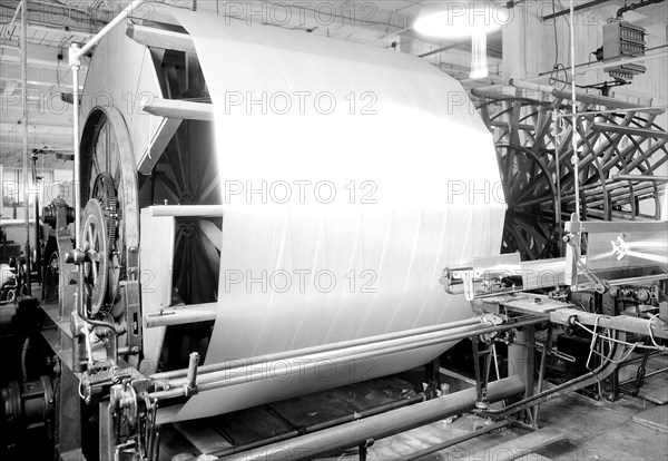 Paterson, New Jersey - Textiles. Jackson Winding and Warping Company. Picture of a Sipp-Eastwood DY type of High Speed Warper. This machine is similar to the one above except that the warp is wound on to the old type of creel. After the warp is made up it is beamed. On this type of machine it takes from 2-1/4 to 2-1/2 hours to make the usual type of warp. This estimate of time may vary slightly one way or the other, depending upon the number of sections, length of the warp, etc, June 1937, Lewis Hine, 1874 - 1940, was an American photographer, who used his camera as a tool for social reform. US,USA