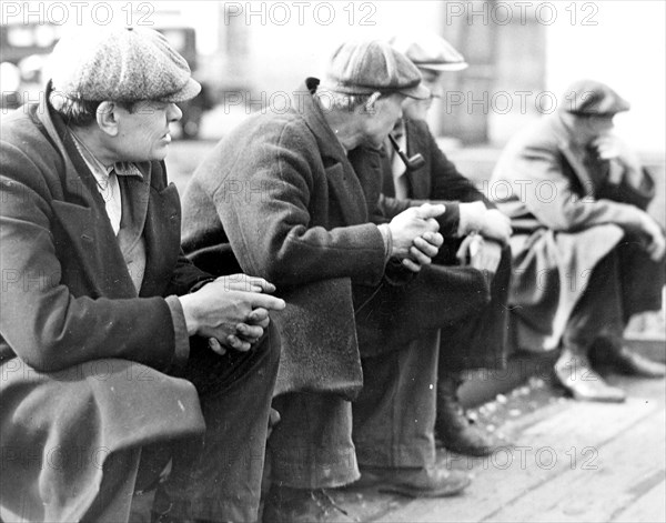 Row of men at the New York City docks out of work during the depression, 1934, Lewis Hine, 1874 - 1940, was an American photographer, who used his camera as a tool for social reform. US,USA