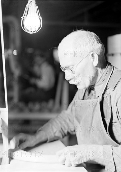 High Point, North Carolina - Upholstering. Tomlinson Chair Manufacturing Co. Upright belt sander chair arm - been at the furniture business 30 years - man and machine in action, 1936, Lewis Hine, 1874 - 1940, was an American photographer, who used his camera as a tool for social reform. US,USA