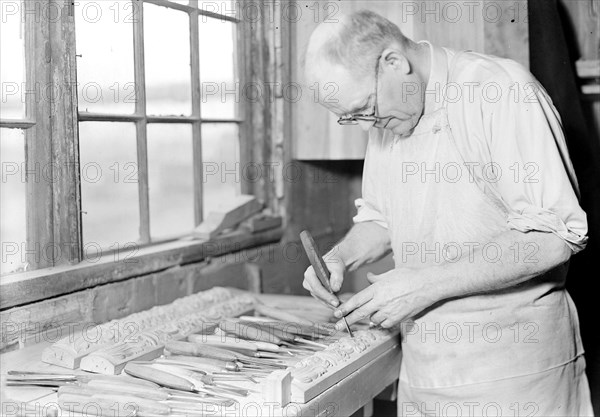 High Point, North Carolina - Upholstering. Tomlinson Chair Manufacturing Co. Hand carver - making master model for multiple carver - buffet post (General View), 1936, Lewis Hine, 1874 - 1940, was an American photographer, who used his camera as a tool for social reform. US,USA