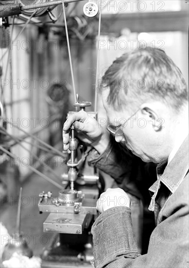 Lancaster, Pennsylvania - Hamilton Watch. Damaskeening - skilled machine operation for putting finishing lines on plates and bridges. A piece of charred ivory is drawn across the plate at proper speed, 1936 , Lewis Hine, 1874 - 1940, was an American photographer, who used his camera as a tool for social reform. US,USA