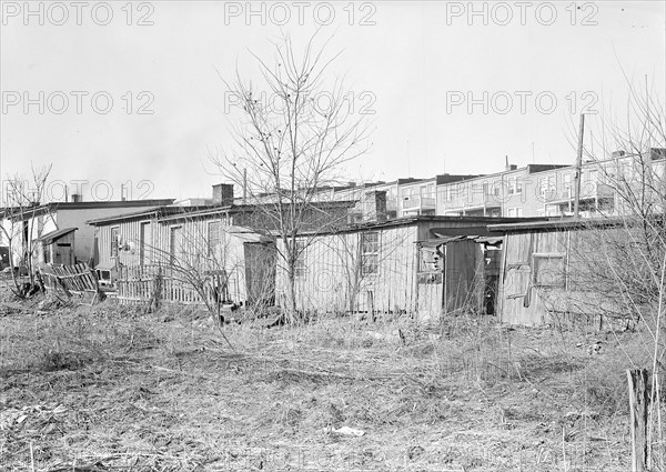 Lancaster, Pennsylvania - Housing. Barney Google Row (street not to be found on city map) - settlement in which live many poor inhabitants of city including some silk and linoleum workers - behind it can be seen the backs of expensive houses on Duke Street, 1936, Lewis Hine, 1874 - 1940, was an American photographer, who used his camera as a tool for social reform. US,USA