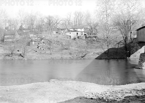 Lancaster, Pennsylvania - Housing. Sunnyside - near covered bridge over Conestoga Creek - dump on one side - shacks on opposite bank - miscellaneous low-paid workers, 1936, Lewis Hine, 1874 - 1940, was an American photographer, who used his camera as a tool for social reform. US,USA