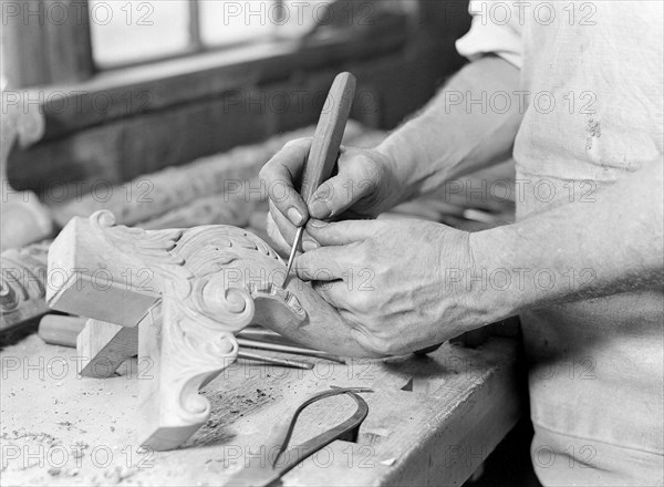 High Point, North Carolina - Upholstering. Tomlinson Chair Manufacturing Co. Hand carver - close-up of man - chair leg - (man has been in this business about 40 years; started at 19 years of age, 1936, Lewis Hine, 1874 - 1940, was an American photographer, who used his camera as a tool for social reform. US,USA