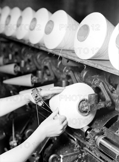 High Point, North Carolina - Textiles. Pickett Yarn Mill. Winder operator - close-up of hands, January 1937, Lewis Hine, 1874 - 1940, was an American photographer, who used his camera as a tool for social reform. US,USA