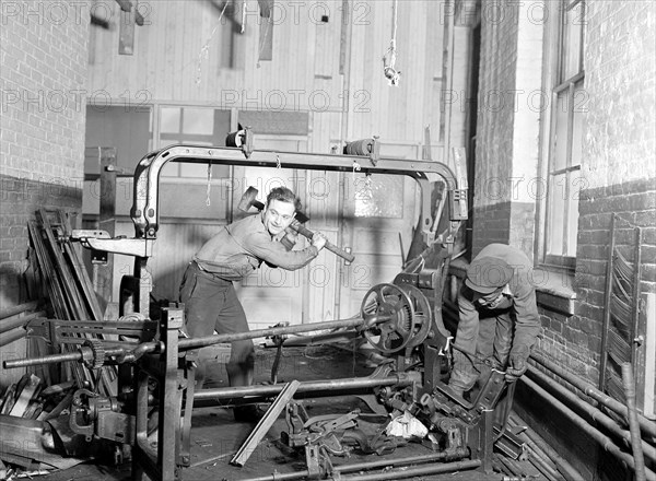 Paterson, New Jersey - Textiles. Junkies breaking up old looms, to be sold for scrap-iron and said to be sent to Japan for munitions, 1936, Lewis Hine, 1874 - 1940, was an American photographer, who used his camera as a tool for social reform. US,USA