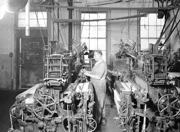 Paterson, New Jersey - Textiles. Weaver operating four-loom system. He is shown removing a used-up quill from the shuttle, 1936, Lewis Hine, 1874 - 1940, was an American photographer, who used his camera as a tool for social reform. US,USA