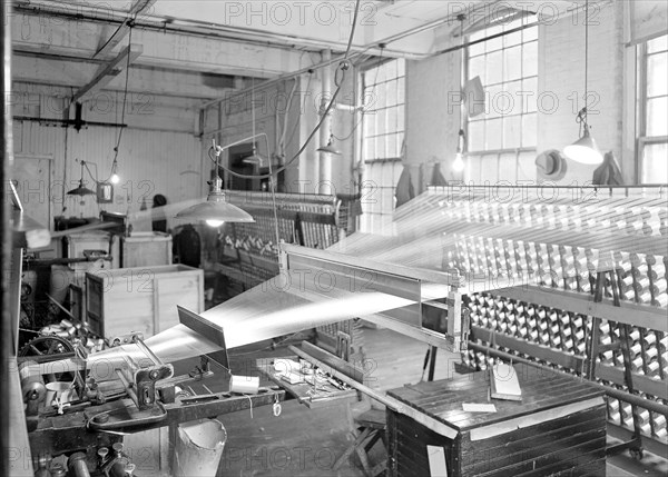 Paterson, New Jersey - Textiles. View of threads going from creel throug the reeds and over the roller. Note the use of reeds in bringing threads to coverge to a very narrow breadth as they go over the roller, March 1937, Lewis Hine, 1874 - 1940, was an American photographer, who used his camera as a tool for social reform. US,USA