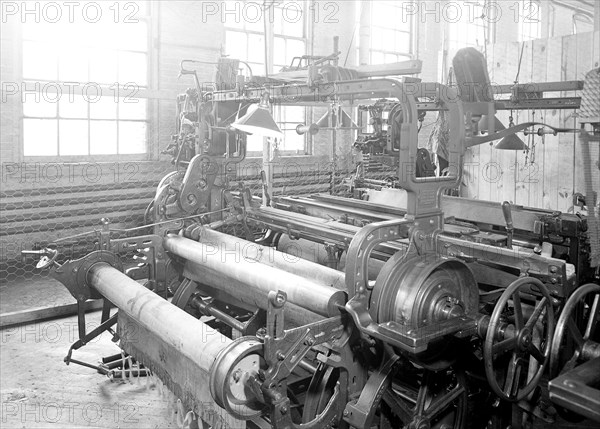 Paterson, New Jersey - Textiles. Idle quilling machines and looms in a cockroach shop. Note partition on the right and chicken-wire in the front, March 1937, Lewis Hine, 1874 - 1940, was an American photographer, who used his camera as a tool for social reform. US,USA