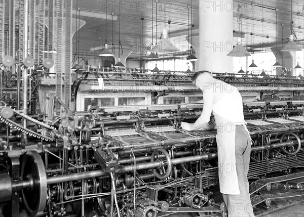 Philadelphia, Pennsylvania - Hosiery. Minnesac Mills. [Man working over long row of machines.], 1936, Lewis Hine, 1874 - 1940, was an American photographer, who used his camera as a tool for social reform. US,USA