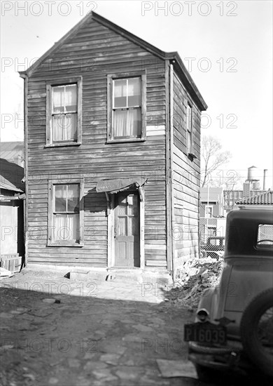 Paterson, New Jersey - Textiles. Two-room home, (kitchen below, bedroom above) of an old retired silk-worker, - in an inner-court on Beech St, March 1937, Lewis Hine, 1874 - 1940, was an American photographer, who used his camera as a tool for social reform. US,USA