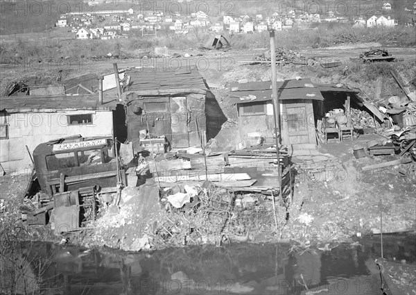 Paterson, New Jersey - Textiles. Bachelor shacks in outskirts of Paterson, on Molly Jan Brook. About 20 men live there now (some of them old silk workers) and stay there all winter. Man in one view worked in silk up to 5 years ago. On relief now, March 1937, Lewis Hine, 1874 - 1940, was an American photographer, who used his camera as a tool for social reform. US,USA