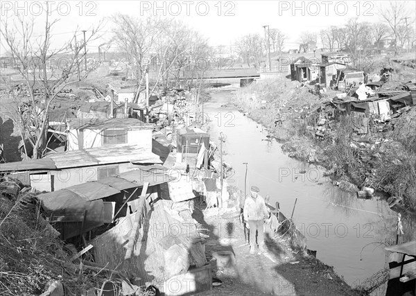 Paterson, New Jersey - Textiles. Bachelor shacks in outskirts of Paterson, on Molly Jan Brook. About 25 men live there now (some of them old silk workers) and stay there all winter. Man in one view worked in silk up to 5 years ago. On relief now, March 1937, Lewis Hine, 1874 - 1940, was an American photographer, who used his camera as a tool for social reform. US,USA