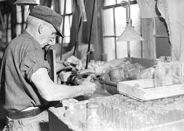 Millville, New Jersey - Glass bottles. T.C. Wheaton Co. A bottle with the stopper may be seen directly in the lower center of the picture, March 1937, Lewis Hine, 1874 - 1940, was an American photographer, who used his camera as a tool for social reform. US,USA