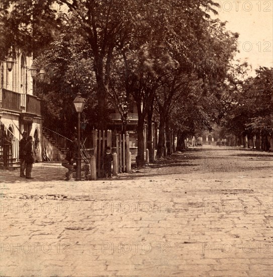 View looking East from the corner of Meeting St. and Broad St., Charleston, S.C., City Hall in the foreground, now used as a Provost Guard House, USA, US, Vintage photography
