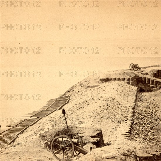 View of Fort Sumpter (i.e. Sumter). On the parapet, overlooking the harbor. Fort Sumter is a Third System masonry sea fort located in Charleston Harbor, South Carolina. The fort is best known as the site upon which the shots that started the American Civil War were fired, at the Battle of Fort Sumter on April 12, 1861. , Vintage photography