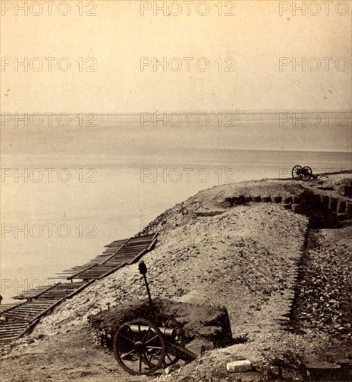 A parapet of Fort Sumpter (i.e. Sumter), looking toward Morris Island. Fort Sumter is a Third System masonry sea fort located in Charleston Harbor, South Carolina. The fort is best known as the site upon which the shots that started the American Civil War were fired, at the Battle of Fort Sumter on April 12, 1861. , Vintage photography