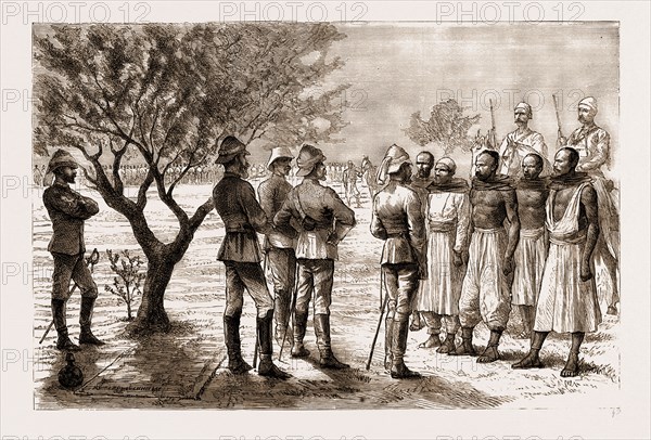 THE REBELLION IN THE SUDAN, 1883: HICKS PASHA EXAMINING ARAB TELEGRAPH WIRE-CUTTERS DURING A HALT: Baron Seckendorff, Hicks Pasha, Major Evans, Interpreter, Colonel Farquhar, Chief of Staff