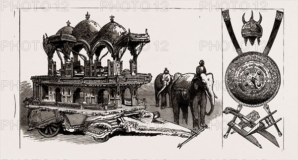 THE INDIAN SECTION OF THE COLONIAL AND INDIAN EXHIBITION: MODEL OF STATE ELEPHANT CARRIAGE BELONGING TO THE MAHARAJAH OF ULWAR, TROPHY OF INDIAN ARMS, 1886