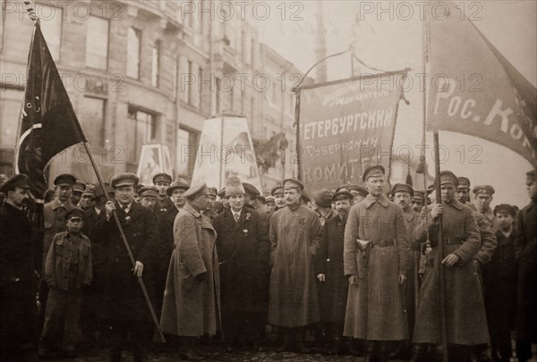 Bolshevik leaders in front of a procession for the 1st of May, 1920. In the center, one recognizes Grigori Zinoviev with an Astrakhan. The central banner reads: "Committee of the Petrograd Province". Petrograd, Saint Petersburg, Russia, History of the Russian Revolution