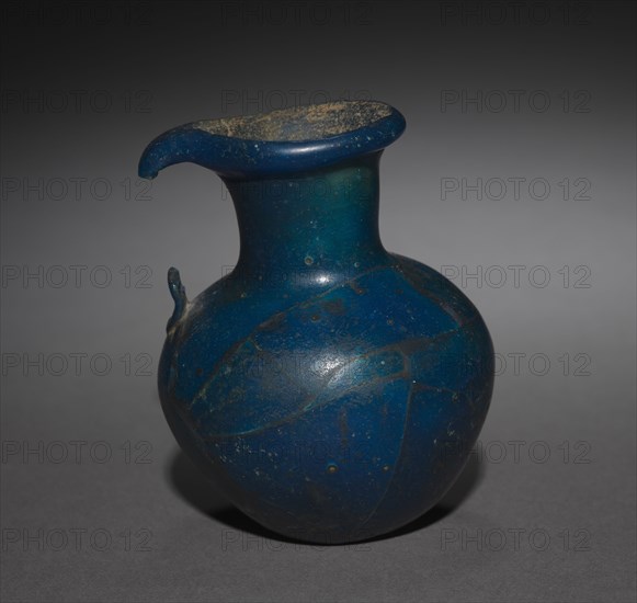 Long-Necked Flask with Strap Handle, 1391-1353 BC. Egypt, New Kingdom, Dynasty 18 (1540-1296 BC), reign of Amenhotep III or later. Glass; diameter: 7.7 cm (3 1/16 in.); diameter of mouth: 4.6 cm (1 13/16 in.); overall: 10 cm (3 15/16 in.).