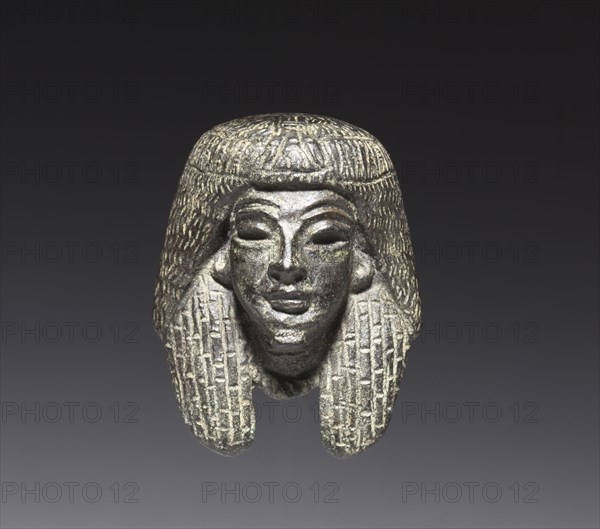 Bronze mount from a "Shawabty Bundle": Head, c. 1336-1256 BC. Egypt, Thebes, Wadi Qubbanet el-Qirud, New Kingdom, late Dynasty 18 (1540-1296 BC) or early Dynasty 19 (1295-1186 BC). Head; bronze face, black copper wig, with traces of gilding; overall: 3.6 x 3.2 x 2.7 cm (1 7/16 x 1 1/4 x 1 1/16 in.).